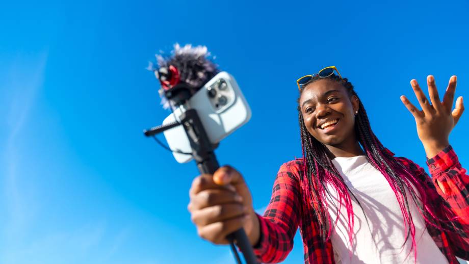 Young creative women collaborating on content creation with a selfie stick